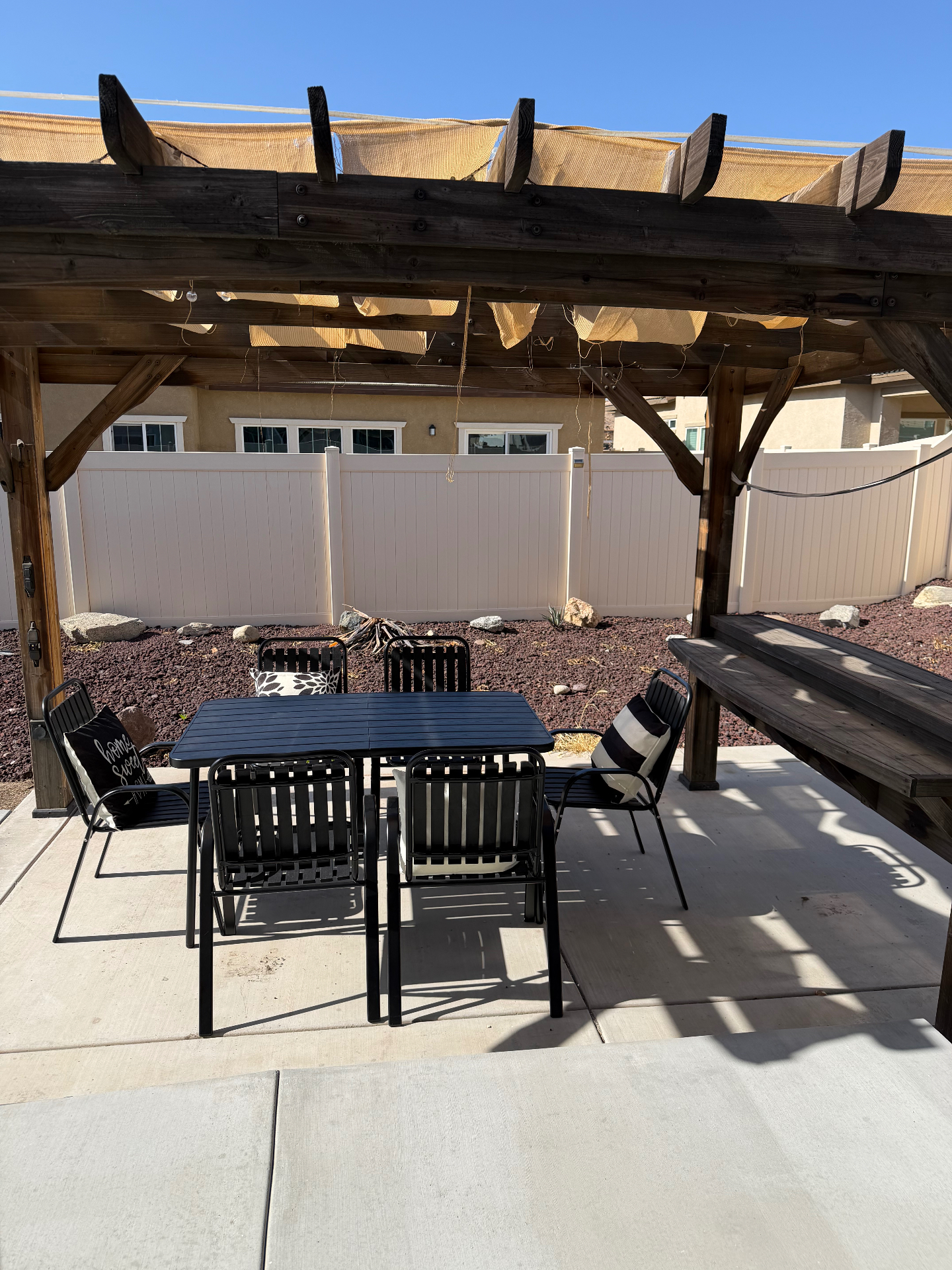 Shaded pergola patio with dining set at Casa De Luna